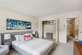 Shrewsbury apartment for rent - A bedroom with a large bed and a painting on the wall.