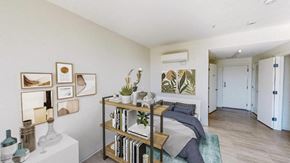 Boston apartment for rent - a bedroom with a bed and a bookshelf in front of it