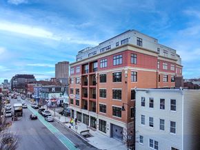 Somerville apartment for rent - a large brick building with many windows and a street in front of it at Union 346 Apartments, Somerville, 02143