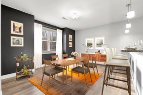 Ashland apartment for rent - Ashland woods apartments in MA dining area with accent wall and vinyl flooring, virtually staged