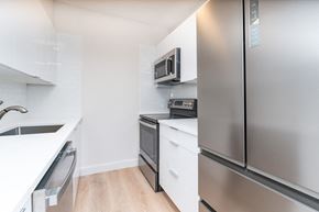 Boston apartment for rent - Babcock Tower two bedroom kitchen with stainless appliances, bright white finishes, microwave, bifold refridgerator