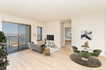 Boston apartment for rent - a living room with a balcony and a couch and a table