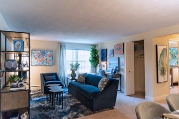 Beverly apartment for rent - a living room with a couch and a chair in front of a window