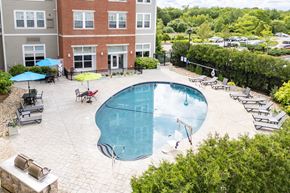 Weymouth apartment for rent - a swimming pool in a courtyard with a brick building