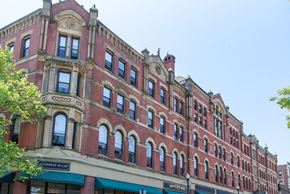 Fall River apartment for rent - A red building with a green awning on the bottom left.