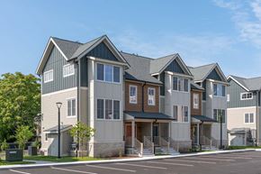 Stoneham apartment for rent - Townhome-style apartment exteriors at The Devon at Weiss Farm in Stoneham, MA with gabled roofs and porches.