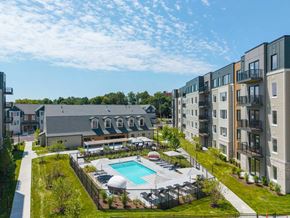 Stoneham apartment for rent - Aerial view of pool and amenity courtyard surrounded by apartments at The Devon at Weiss Farm in Stoneham, MA.