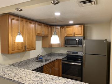 Stoughton apartment for rent - a kitchen with granite counter tops and stainless steel appliances