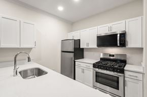 Lynnfield apartment for rent - A kitchen with white cabinets and stainless steel appliances.