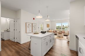 Somerset apartment for rent - A modern kitchen with white cabinets and a wooden floor.
