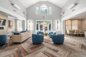 Lynnfield apartment for rent - A spacious waiting room with blue chairs and a large window.