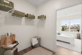Somerset apartment for rent - A bedroom with a white bed and a window overlooking a cityscape.