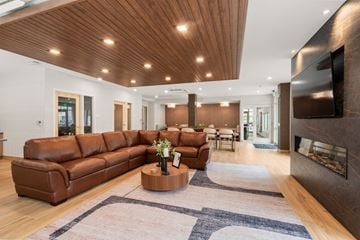 Somerset apartment for rent - A modern living room with a brown leather sofa and a wooden coffee table.