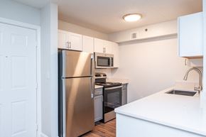 Woburn apartment for rent - a renovated kitchen with stainless steel appliances and white cabinets