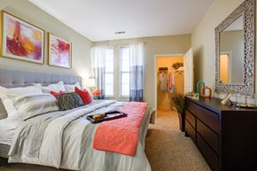Lynnfield apartment for rent - A bedroom with a large bed and a mirror on the wall.