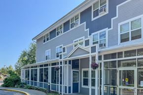 Taunton apartment for rent - A building with a blue and white exterior and a covered porch.