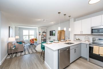 Quincy apartment for rent - a kitchen with an island and a living room with a couch