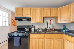 Framingham apartment for rent - Pelham model apartment kitchen with wood cabinets and stove