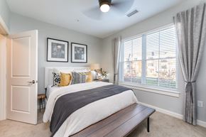 Plymouth apartment for rent - model bedroom with plush carpeting and ceiling fan
