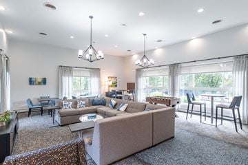 Shrewsbury apartment for rent - a living room with a couch and a table with chairs