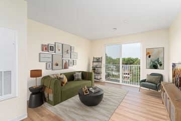 Somerset apartment for rent - A living room with a green couch and a wooden floor.
