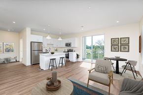 Somerset apartment for rent - Fully staged great room—kitchen with island seating, dining set and lounge furniture—flowing to a balcony through glass doors.