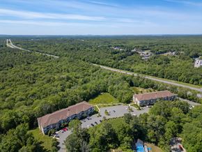 Hanover apartment for rent - A bird's eye view of a large building surrounded by trees and a parking lot.