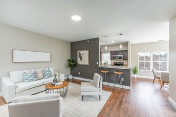 Hanover apartment for rent - A living room with a white couch and a bar area.