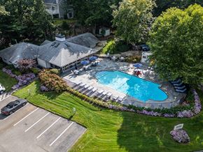 Weymouth apartment for rent - an aerial view of a swimming pool in a backyard with a pavilion and lawn
