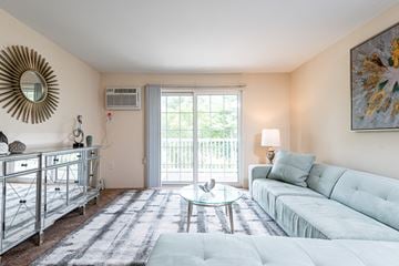 Salem apartment for rent - a living room with a white couch and a sliding glass door