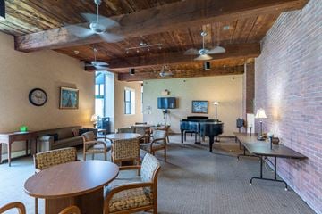Andover apartment for rent - a living room with a piano and tables and chairs