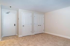 Weymouth apartment for rent - a bedroom with three closets and a carpeted floor