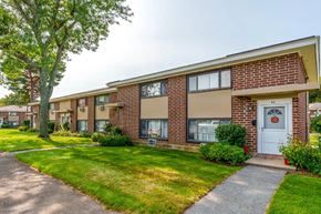 Framingham apartment for rent - A brick house with a white door and windows.