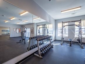 Lowell apartment for rent - A well-appointed fitness center featuring free weights and strength training equipment.