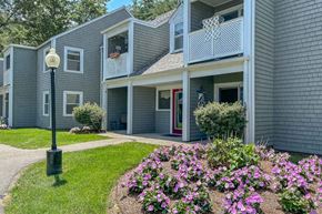 Hanover apartment for rent - A grey building with a flower bed in front.