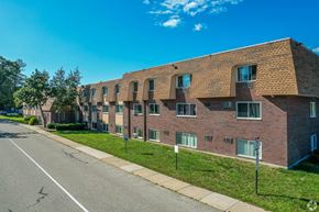 Framingham apartment for rent - Aerial view of The Chesterfields' mansard roofed building with lush landscaped lawns.