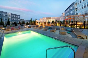 Weymouth apartment for rent - a pool with lounge chairs and a building in the background