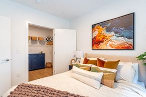 Chelsea apartment for rent - A bedroom with a large bed and a painting on the wall.