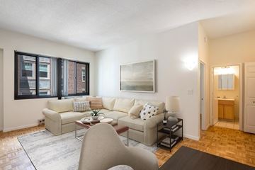 Cambridge apartment for rent - A living room with a couch, chair, and a painting on the wall.