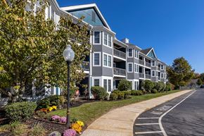 South Easton apartment for rent - A street view of a residential area with apartment buildings and a sidewalk.