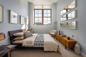 Lawrence apartment for rent - a bedroom with a bed and some windows
