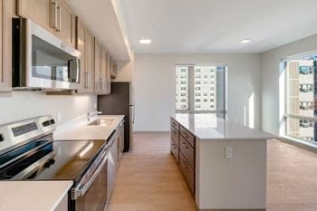 A kitchen with a stove top oven and a microwave