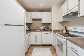 E. Boston apartment for rent - a kitchen with white cabinets and appliances and a sink at Chapman House, E. Boston, MA