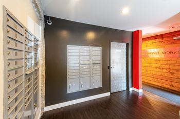 A hallway with a door to a wine room and a wall with a wooden wall