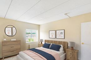 Framingham apartment for rent - A bedroom with a bed, nightstand, and two framed pictures on the wall at Edmands House, Massachusetts, 01701