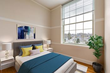 A bedroom with a bed and a large window