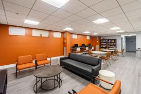 Greenfield apartment for rent - a lounge area in a library with chairs and tables at Mill House Apartments, Greenfield, MA 01301