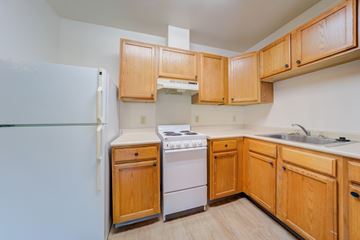 Edinboro apartment for rent - A kitchen with wooden cabinets and a white refrigerator.