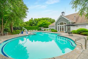Abington apartment for rent - a swimming pool with a house in the background at Woodlands at Abington Station, Abington, MA, 02351