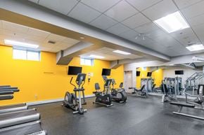 Framingham apartment for rent - A gym with a variety of equipment including treadmills, weights, and exercise machines at Edmands House, Framingham, 01701